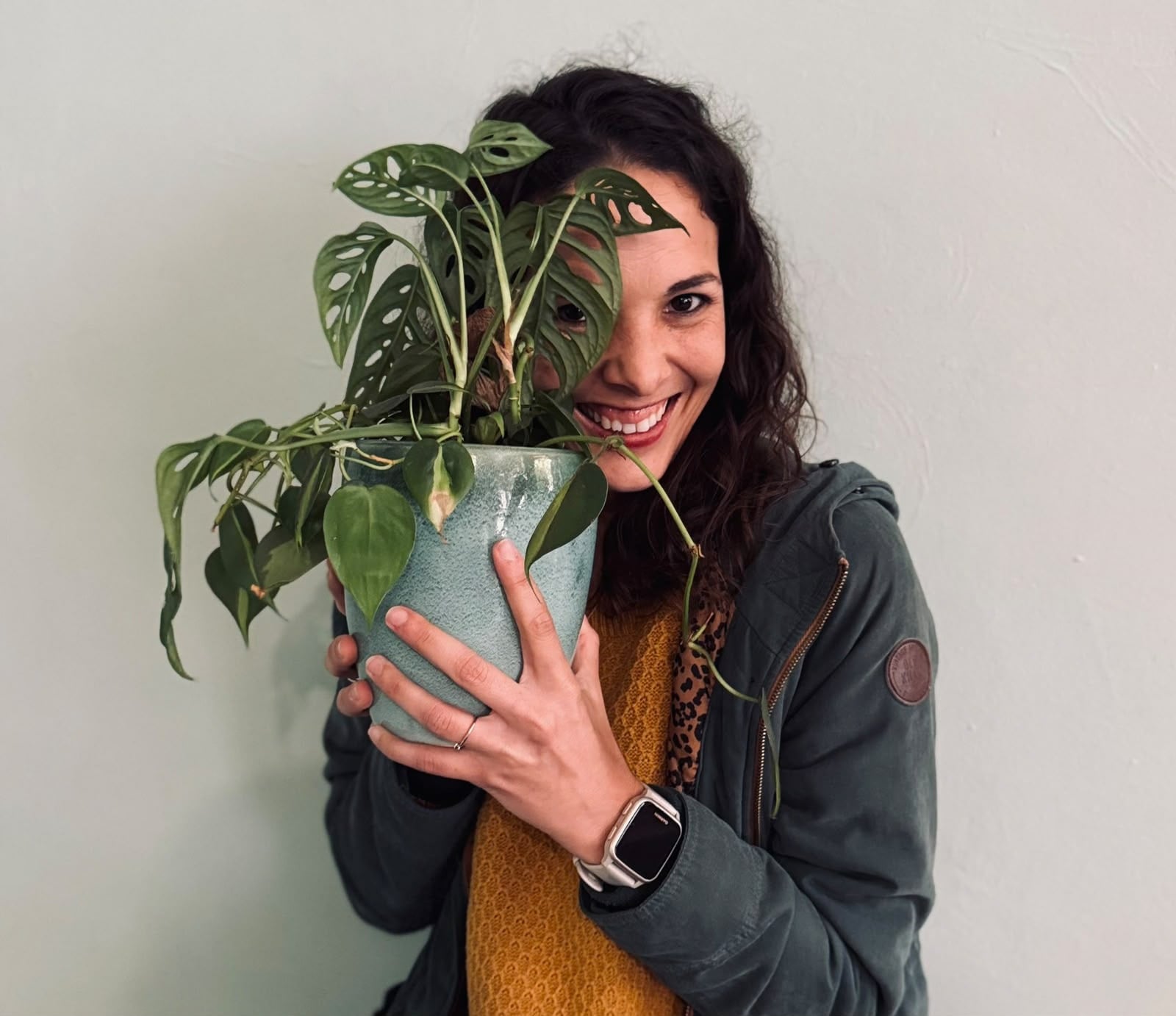 Leeze holding a leafy houseplant